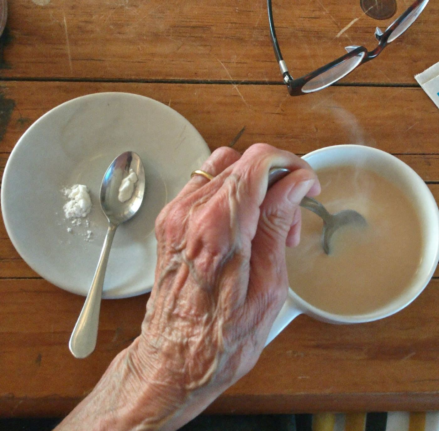 Stirring goat milk powder into a cup of tea